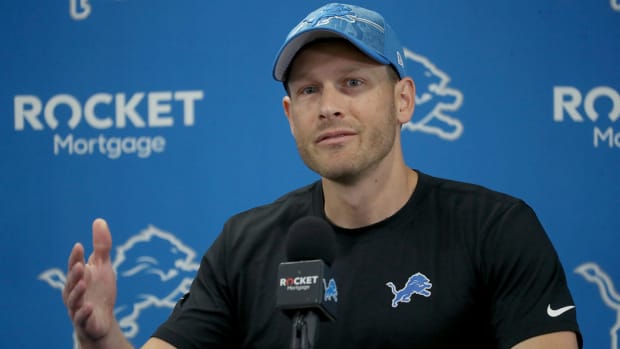Lions offensive coordinator Ben Johnson talks with reporters before training camp.